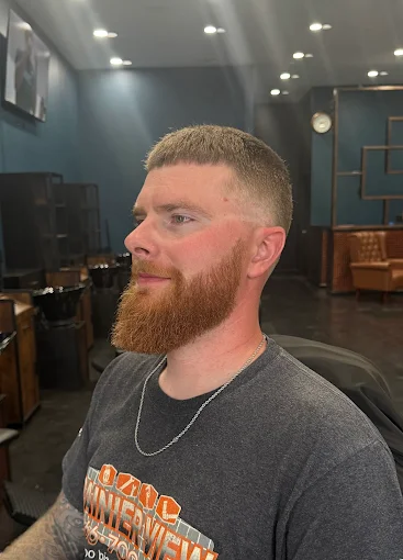 Client with a shaped ginger beard and fresh barber finish